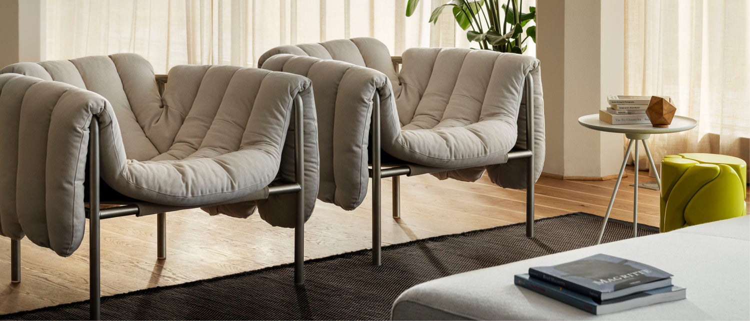 Hem - A living room scene featuring two Puffy Lounge Chairs, Dune Rug, Palo Sofa, and Key Side Table.