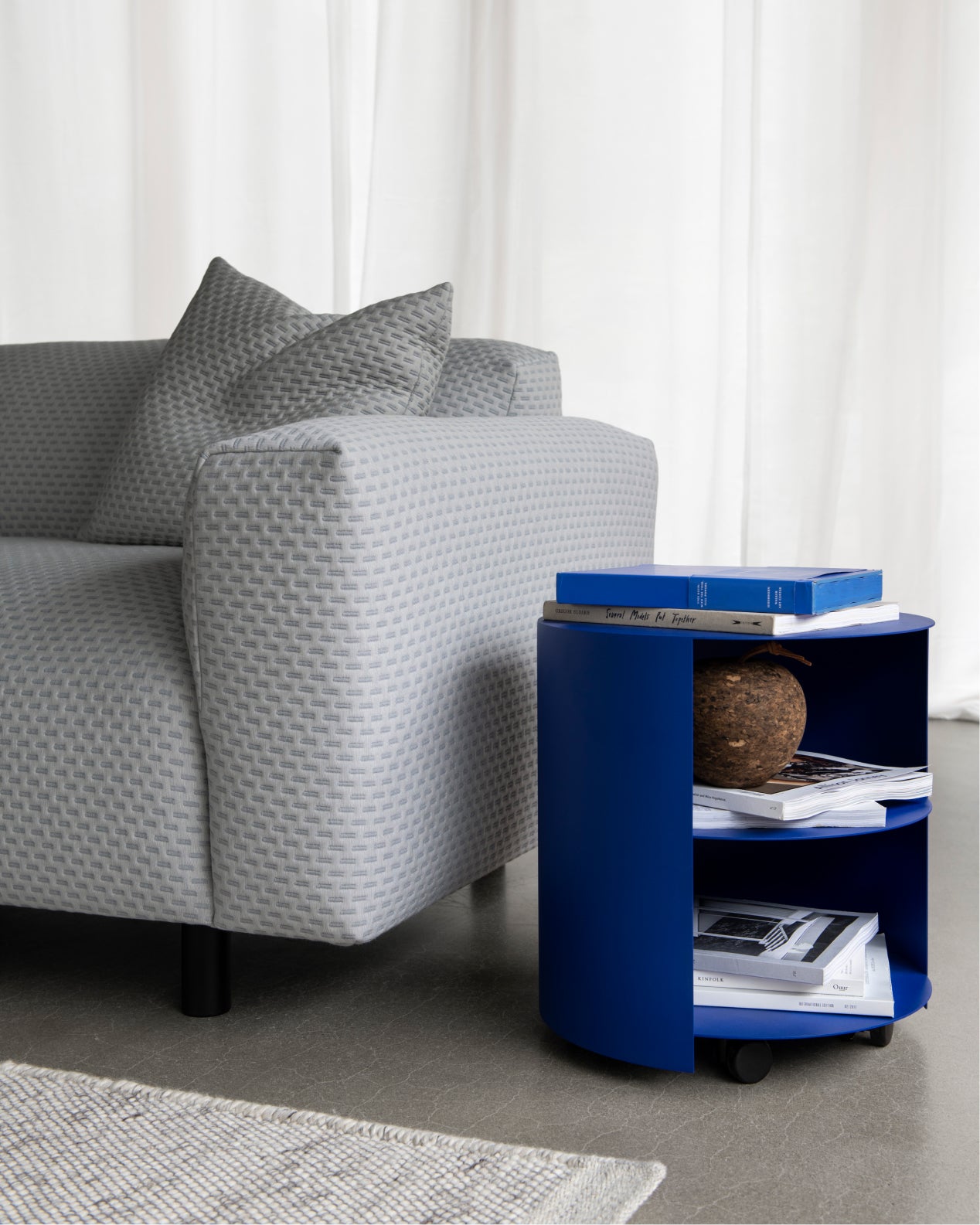Hem - A lifestyle image featuring Hide Side Table Ultramarine Blue and Koti Sofa in Dash Light Grey.