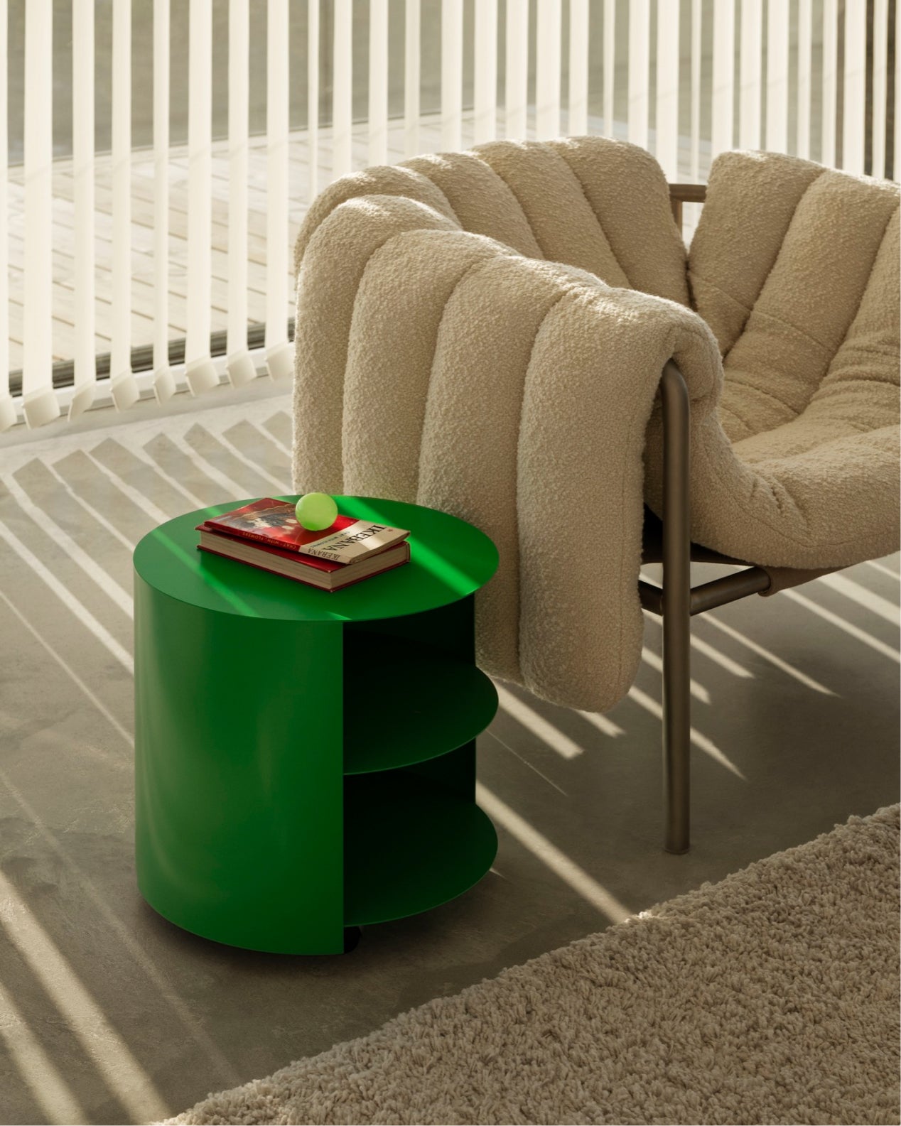 Hem - A lifestyle image featuring Hide Side Table in Pure Green and Puffy Lounge Chair in Eggshell / Stainless.