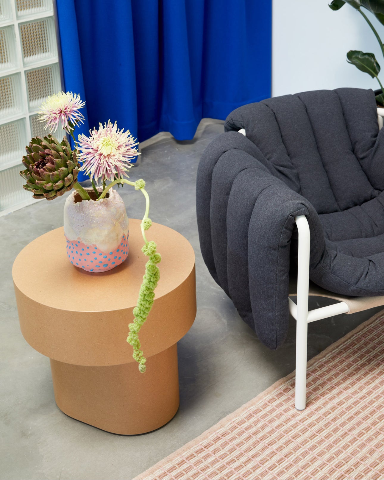 Hem - An image from our LA Showroom featuring Puffy Lounge Chair, Rope Rug, and Stump Side Table Natural.
