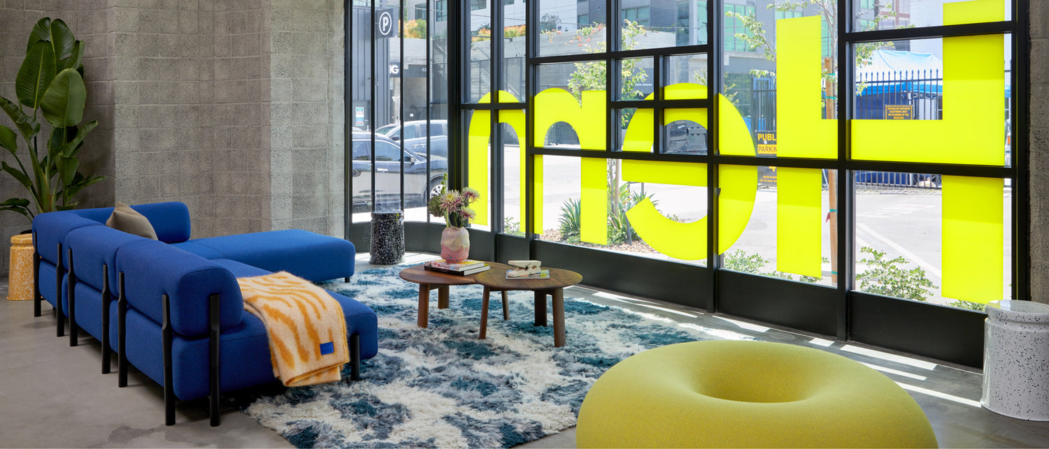 Hem - An inside view of our new LA showroom featuring Boa Pouf, Palo Corner Sofa Left, Monster Rug, Monster Throw, Alle Coffee Tables, Last Stools, and more.