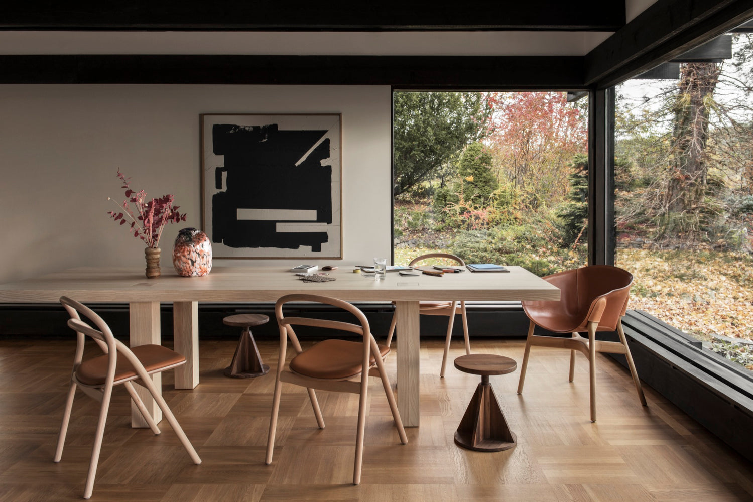 A lifestyle image of a dining scene featuring Max Table, Udon Upholstered Chairs, All Wood Stool and Pocket Armchair.